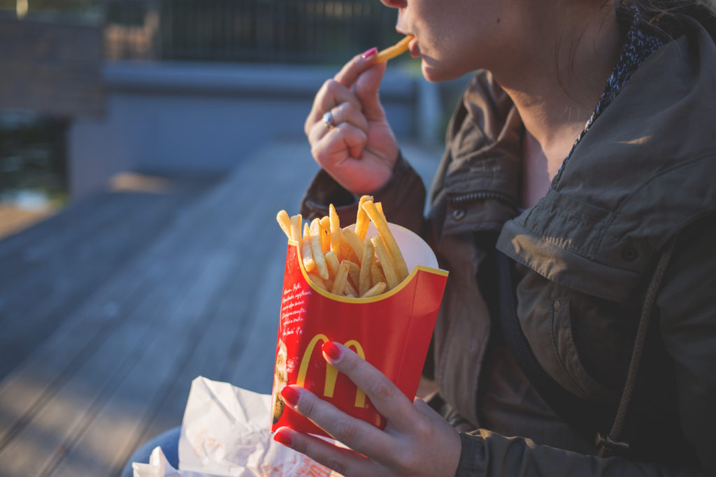 woman eating McDonald's French fries