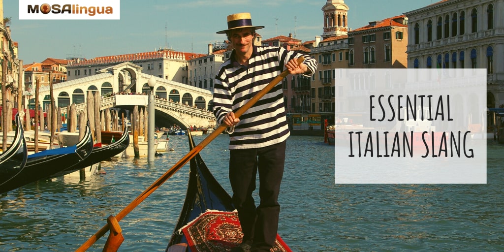 A man with a mustache, wearing a straw hat and a black and white striped shirt is paddling a gondola boat in a canal in Italy. There is a bridge in the background. Text reads: Essential Italian Slang Expressions. MosaLingua.