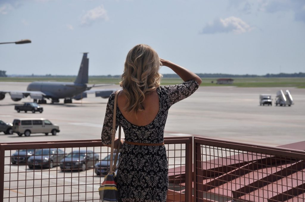 woman looking at airplanes on tarmac