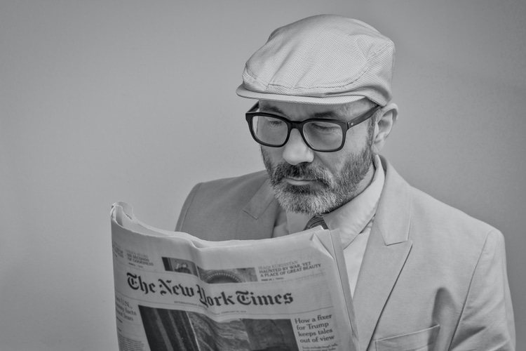 man reading new york times newspaper