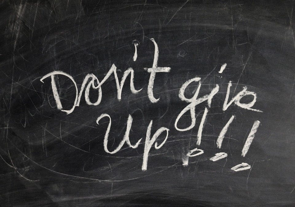 Chalk board with writing that says Don't give up!!