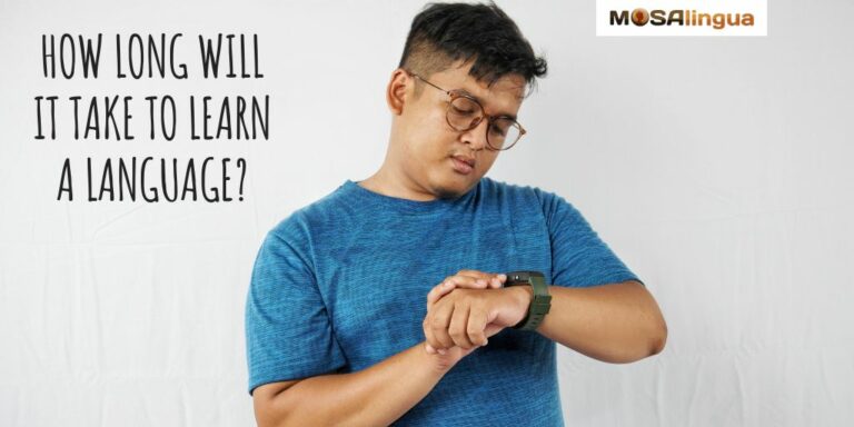 A man in a blue t-shirt and glasses looks at his wristwatch. Text reads: How long does it take to learn a language? MosaLingua