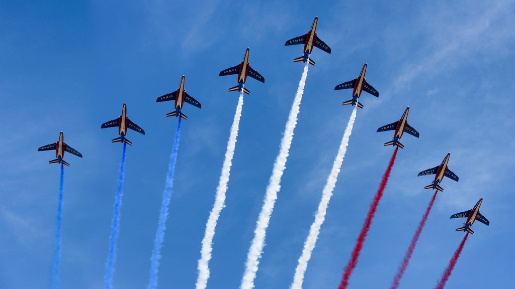 saying cheers in french nine airplanes with blue white and red smoke trailing them