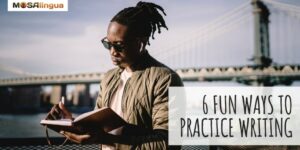 African American man wearing earbuds and sunglasses and writing in a journal in front of a bridge over the water. Text reads: 6 fun ways to practice writing in a foreign language. MosaLingua.