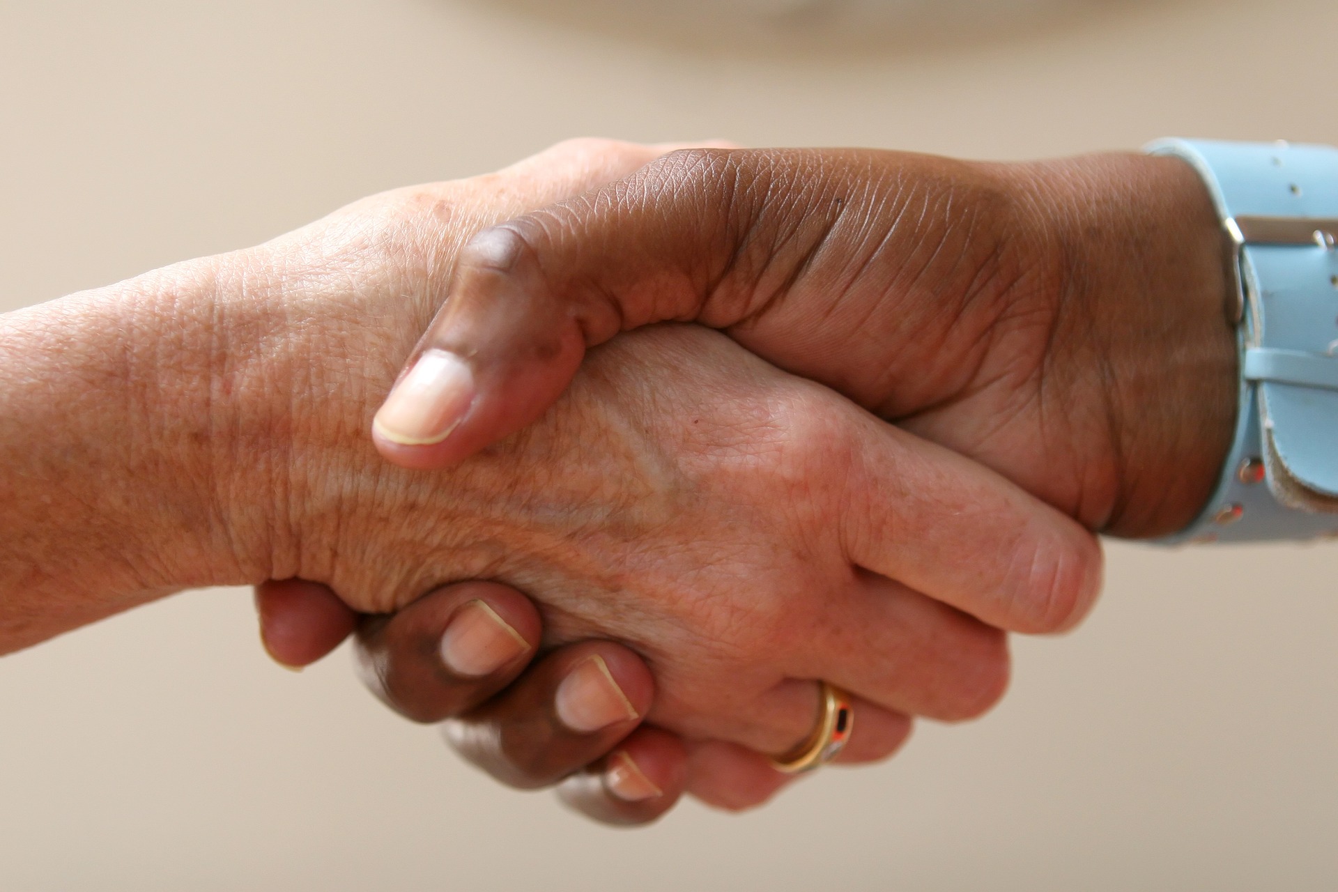Close-up photograph of two people shaking hands.