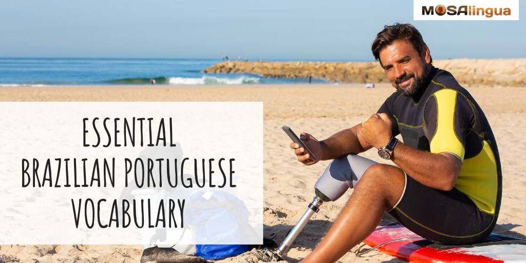 Man sitting on a surfboard on the beach, smiling at the camera with a smartphone in his hand. Text reads: Essential Brazilian Portuguese Vocabulary. MosaLingua.