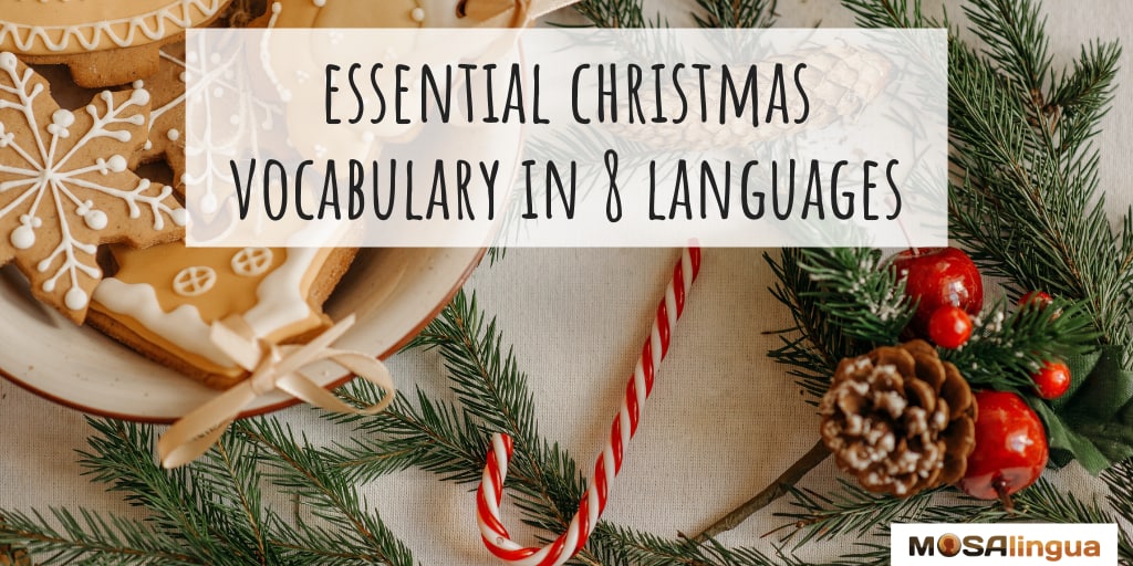 Christmas cookies, a candy cane, and part of a wreath with pinecones and red berries. Text reads: Essential Christmas vocabulary in 8 languages. MosaLingua