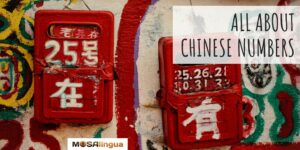 Painting with white, green, and red. There are two red boxes with Chinese symbols and numbers painted on them in white. Text reads: All about Chinese numbers. MosaLingua.