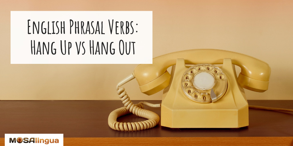 Yellow rotary phone with the text "English phrasal verbs: hang up vs. hang out.