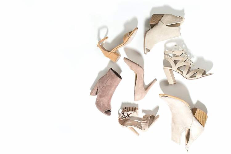 Seven women's white heels laying on a white background. "To put yourself in someone's shoes" is a common English idiom that means to try and see things from their perspective.