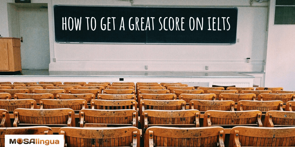 View of the blackboard in a classroom and empty rows of wooden seats. Text on blackboard reads: How to get a great score on IELTS. MosaLingua