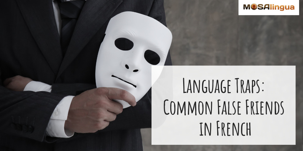 A man in a suit holds a mask. text reads: "Language Traps: Common False Friends in French."