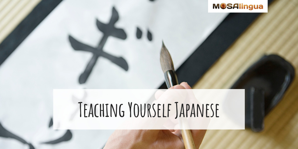Image of a hand writing Japanese calligraphy. Text reads "Teaching yourself Japanese." Part of "How to Learn Japanese" article.