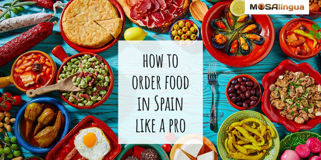 A blue table full of Spanish tapas dishes such as tortilla española, olives, chorizo, and mushrooms. Text reads: How to order food in Spanish like a pro. MosaLingua