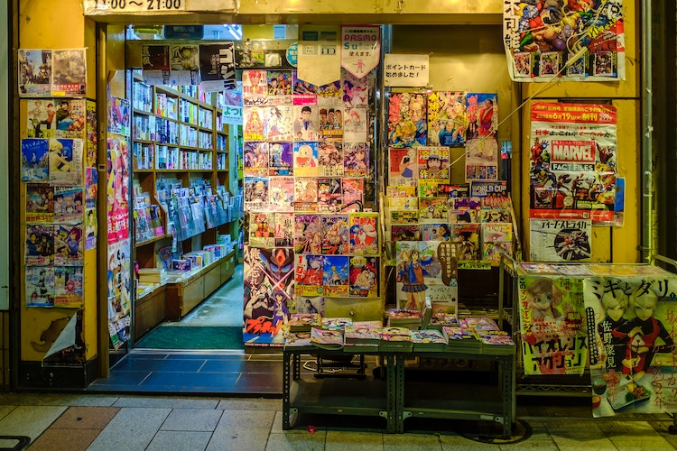 A storefront in Tokyo full of different Japanese manga.