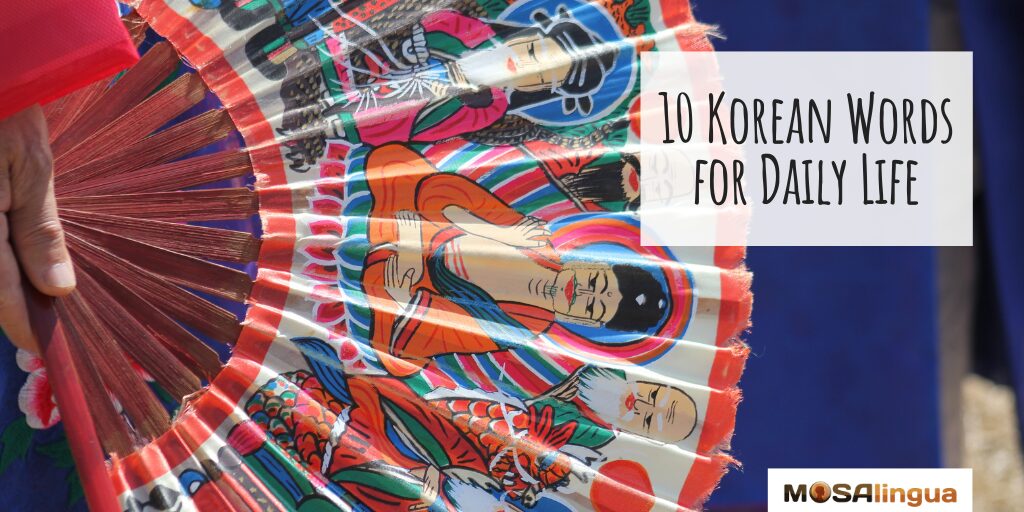 Image of a hand holding a fan painted with Korean spiritual figures. Text reads "10 Korean Words for Daily Life."