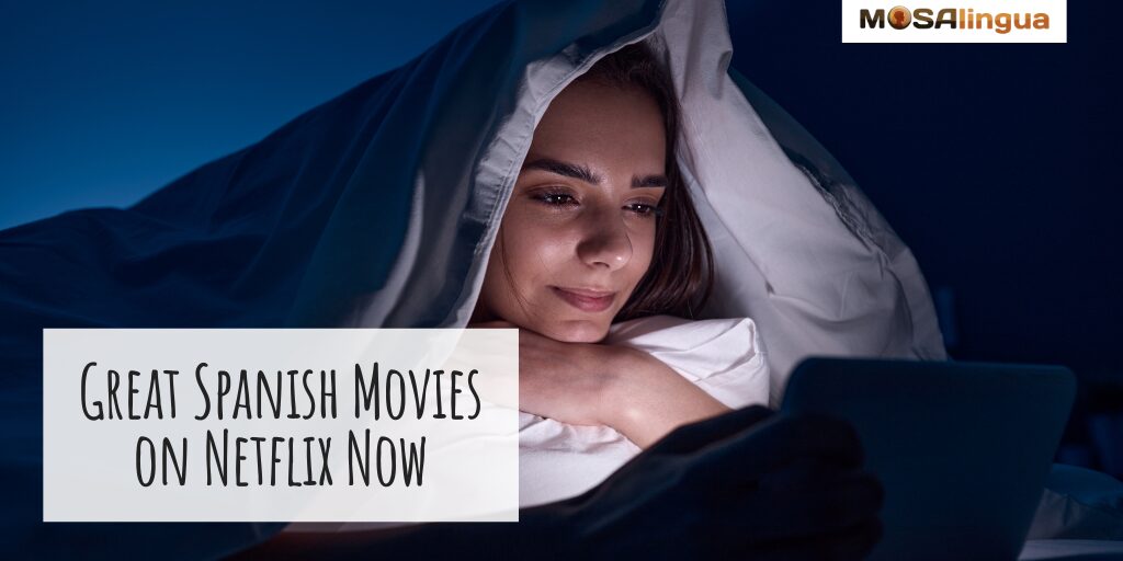 Image of a woman wrapped in bedsheets watching a movie on a laptop. From Best Spanish Movies on Netflix article.