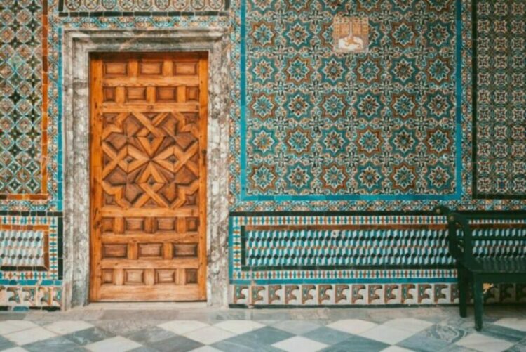 Image of an ornate wooden door in a colorful room. 100 Most Common Spanish Words article.